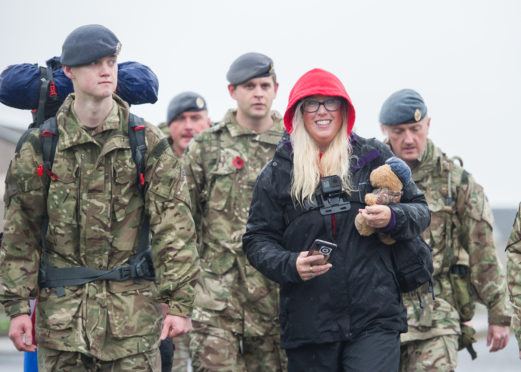 Emma Knutzen walks the final yards to RAF Lossiemouth with her son Jake.