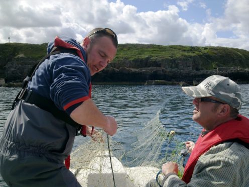Illegal monofilament gill net being retrieved in the Moray coastline by Water Bailiffs.  Left to right are Richard Whyte and Jason Hysert from the Spey Fishery Board.