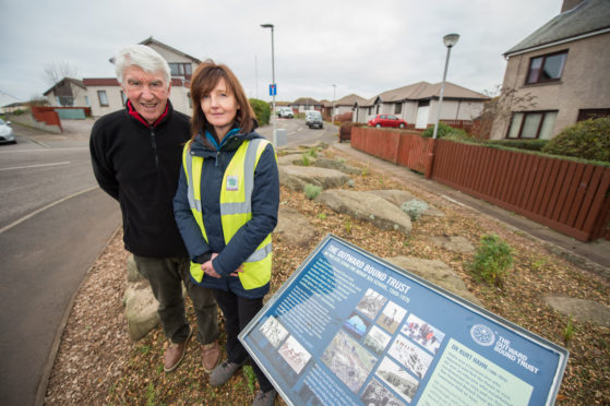 Ed McCann and Greenfingers Training Service officer Pam Lewis beside the Moray Sea School plaque