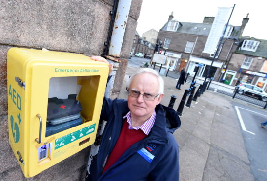 Stonehaven Community Council Chairman Raymond Christie at the defibrillator.