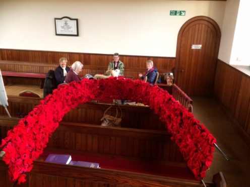 The entrance of Cromdale and Advie Church had been decorated with poppies knitted by the community
