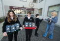 Students Alannah Ayres, Ben Cameron and Millan Ormsby sell rice at Speyside High School.