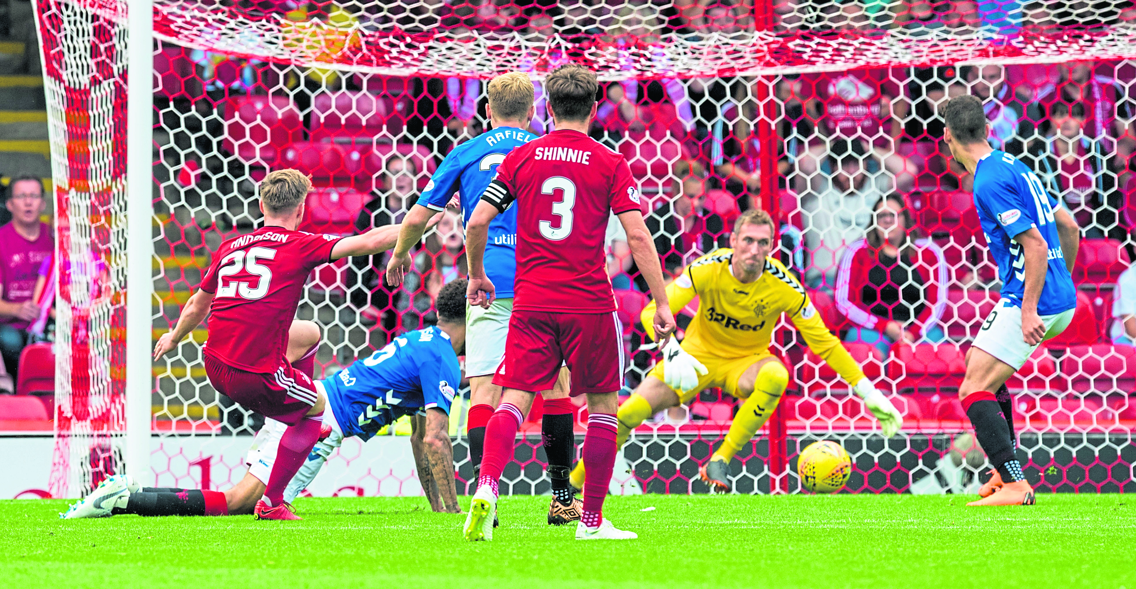 Bruce Anderson, left, scores a late equaliser in the Dons’ league clash with Rangers to the delight of fans and manager Derek McInnes in 2018.