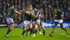 Sean Maitland is tackled by South Africa's Steven Kitshoff (left)