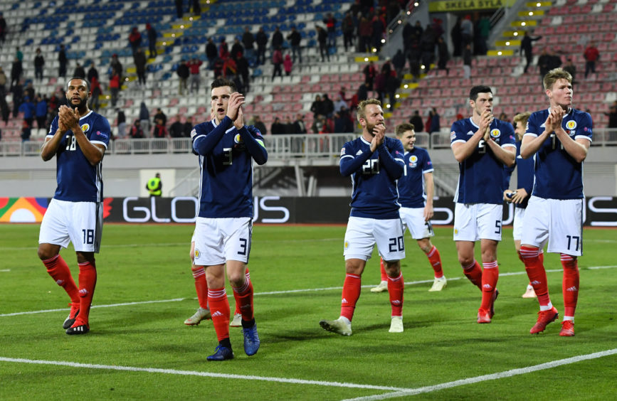 The Scotland team applaud the fans at full-time.