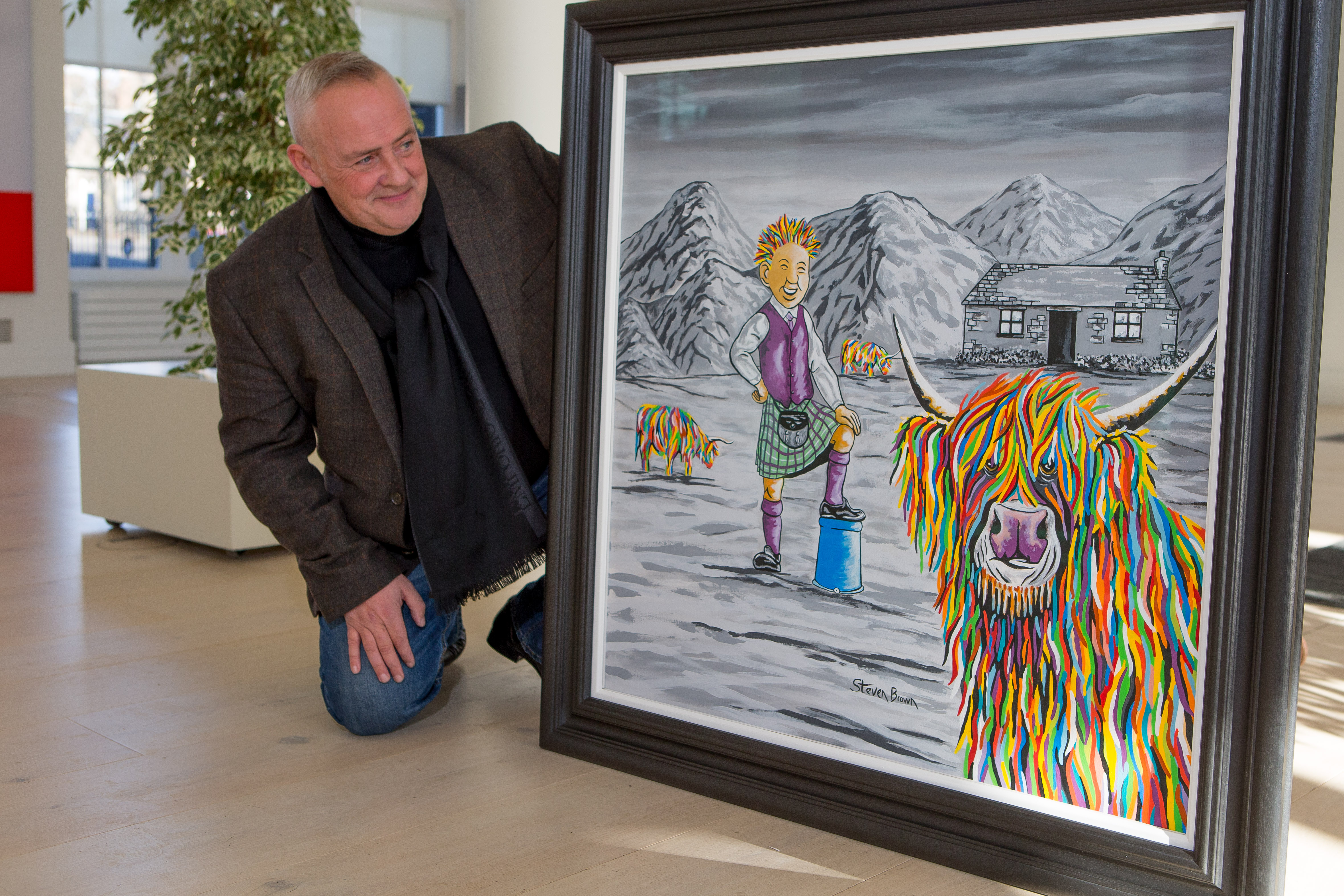Artist Steven Brown with a special artwork depicting McCoo and Oor Wullie, commissioned by DC Thomson.
