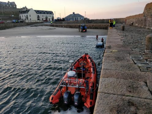 RNLI assisting with the removal of the car from the water on Saturday