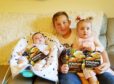 Karen and Robert Horne's grandchildren with the published cookbook written by their late grandparents.