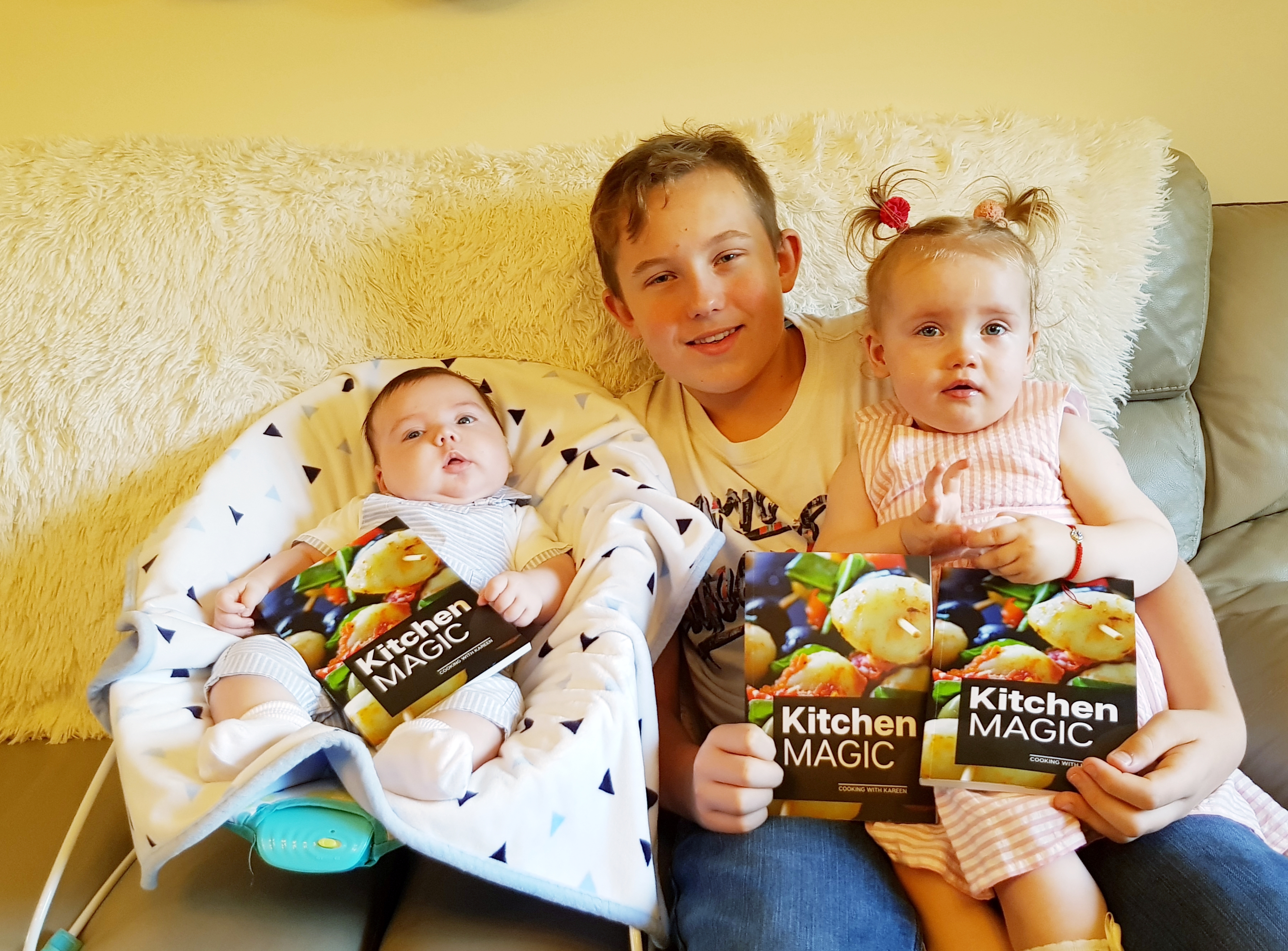 Karen and Robert Horne's grandchildren with the published cookbook written by their late grandparents.