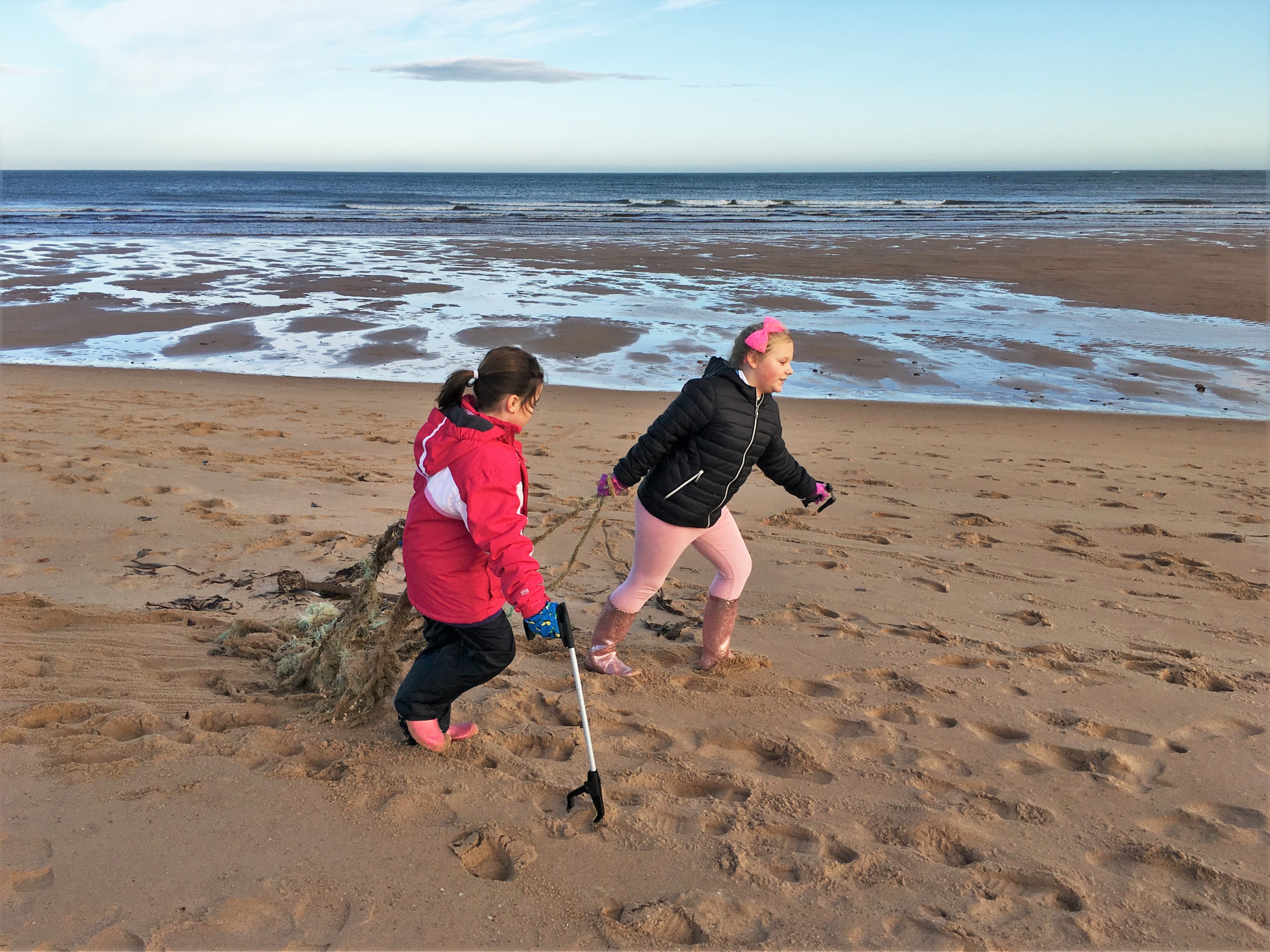 Two of the 17 young volunteers from Kininmonth Primary School clearing up Ugie Beach, Peterhead