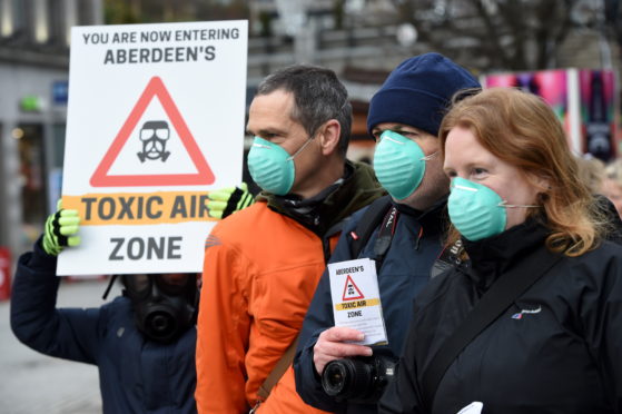 Campaingers held signs and wore masks