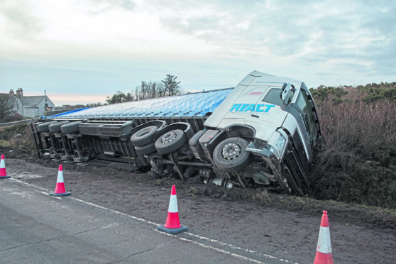 This artic lorry caught the verge, and overturned.