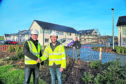 Pictured L-R at the Grainbank development on Orkney are Stephen Kemp of Orkney Builders; Craig Shearer, Openreach ops manager for Orkney; and, in the background, Dominic Dransfield, Openreachs newest recruit on Orkney.