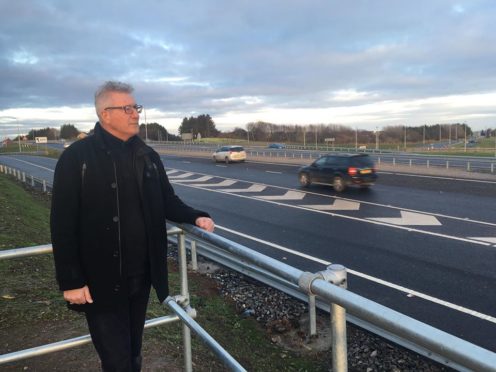 Dave Douglas surveys the slip road leading to the AWPR from outside his home