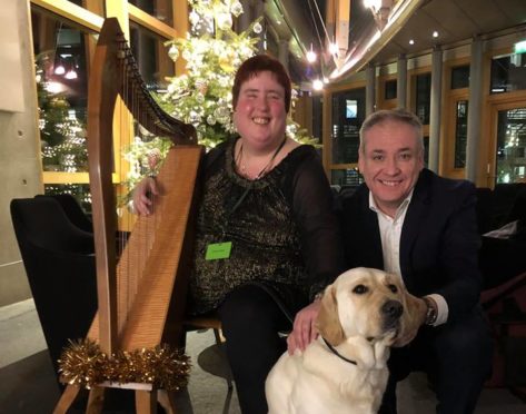 Fiona Kyle, Richard Lochhead MSP and Gus the guide dog