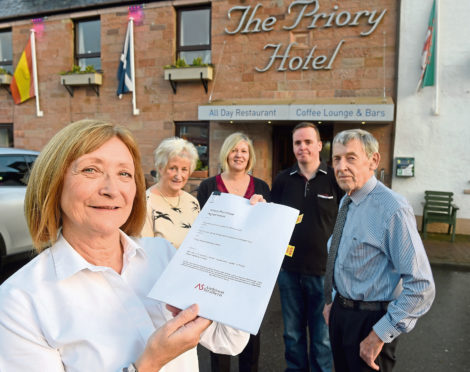 Member of staff, Veronica Finlay (left) with Eveline (second left) and Stuart (right) Hutton while in the centre are fellow employees Barry Wright and Janet Munro.