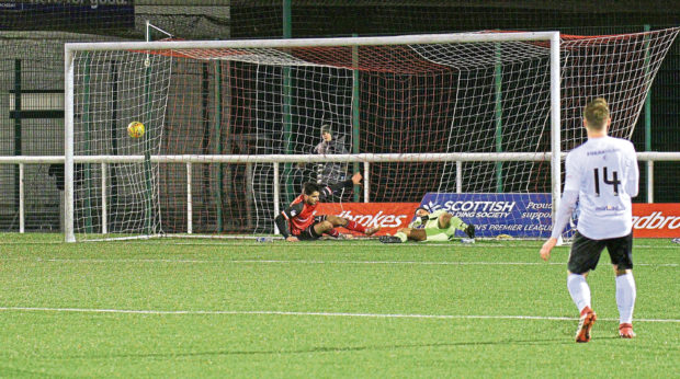 Rabin Omar bundles the ball into the Edinburgh net.