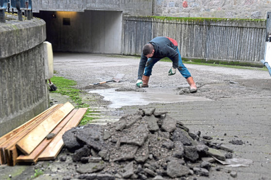 Repair work being carried out on the road surface at the Town House car park entrance.