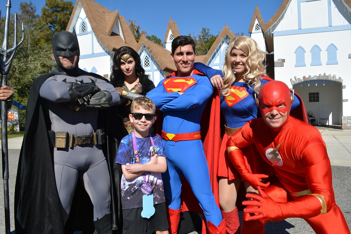 Alex Crichton posting with superheroes at Disney World in Florida