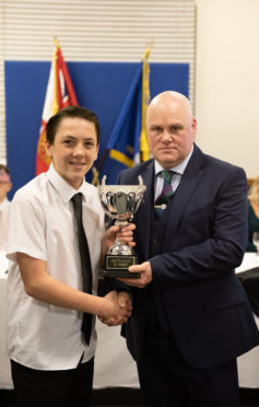 Cadet Liam Munro receiving his Excellence in Sport award from Lt Garry Smith the Forres Detachment Commander