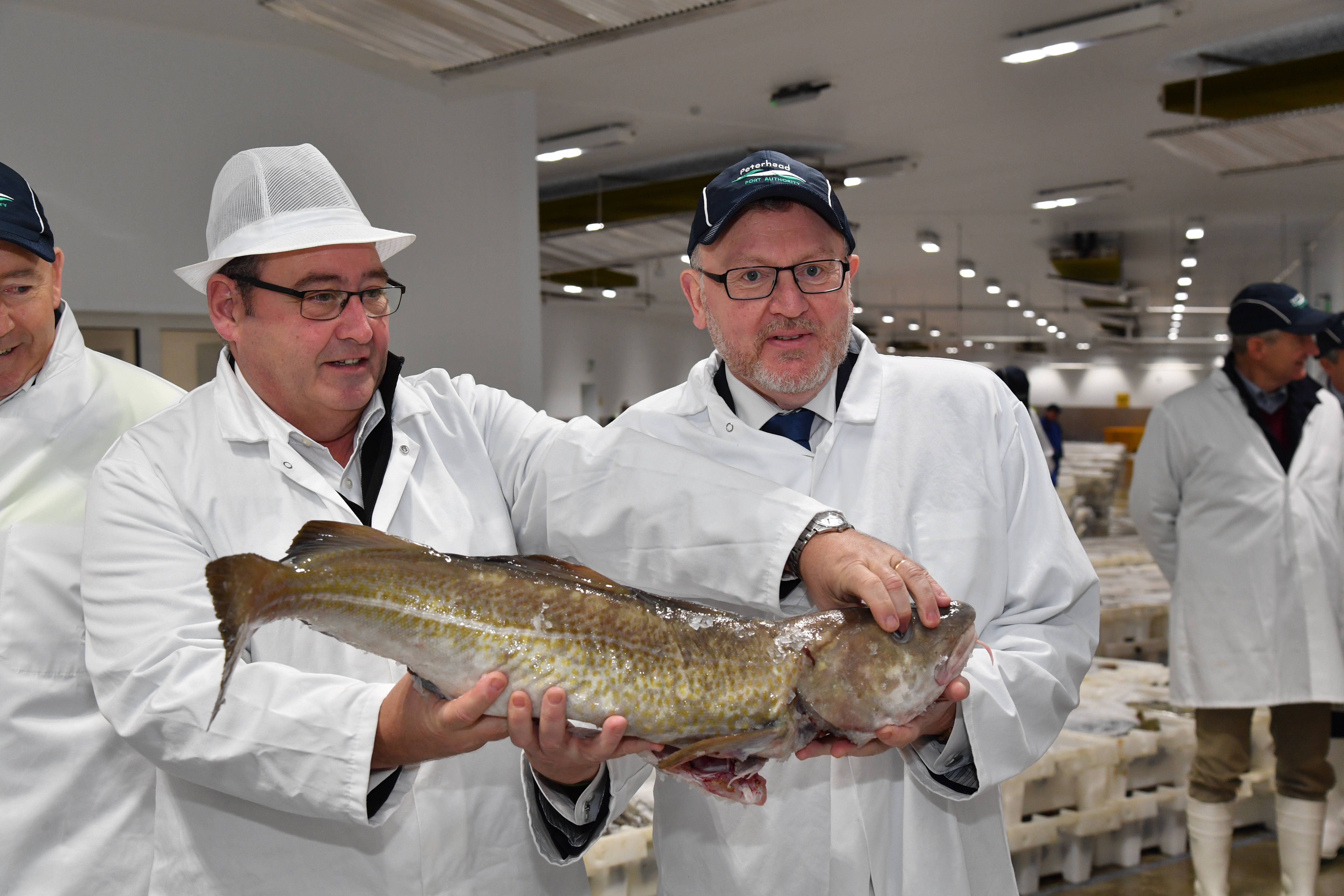 Secretary of State for Scotland David Mundell (right) with Jimmy Buchan and a cod from the Peterhead Fish Market