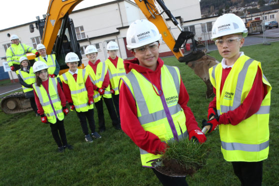 Head girl and boy Lusiana Vukicea and Travis MacPherson do the honours while house captains, from left, Myha Alexander-Rouse, Harry Donaldson, Kris Clark and Euan Beaton look on. Behind are Morgan Sindall’s Patrick Johnson, Mrs MacCormick and Alex Graham