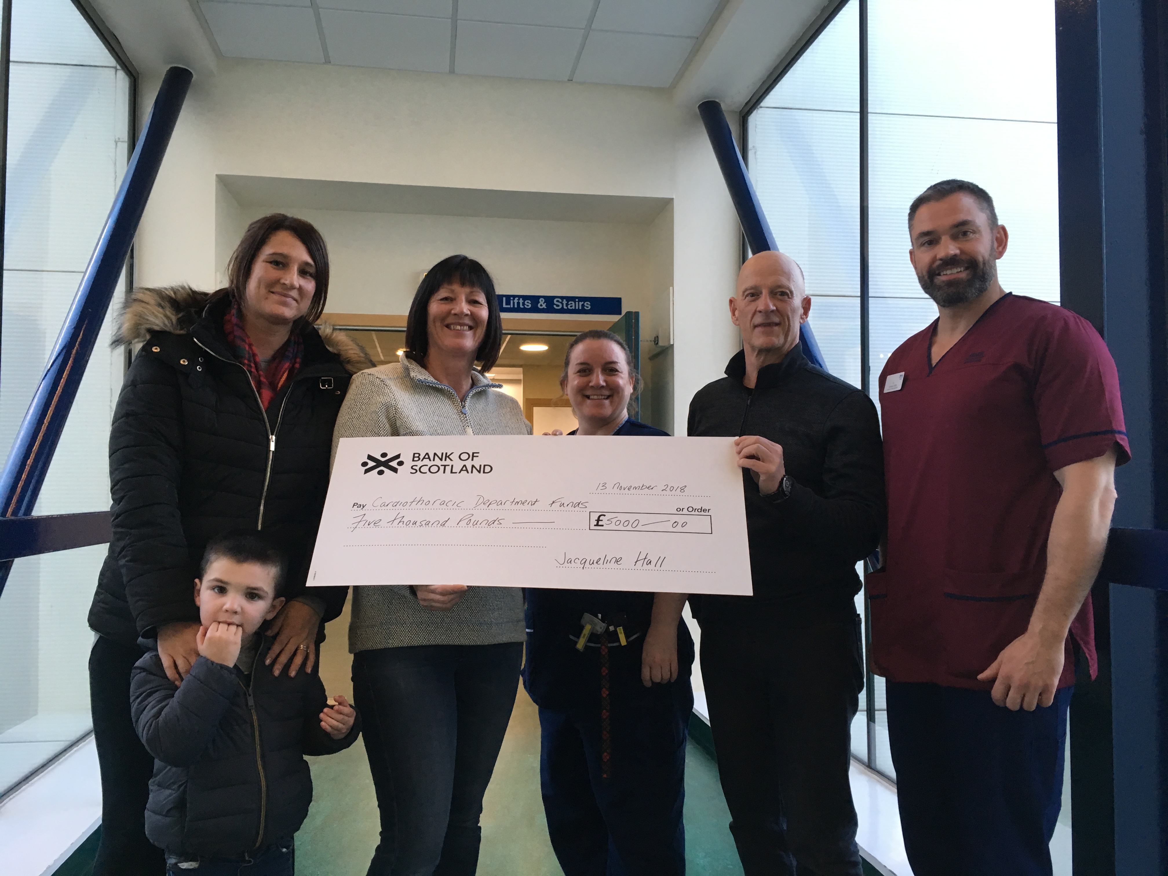 Jackie Hall raised £5,000 for Edinburgh Royal Infirmary in memory of her father. Pictured: Laura Mulholland, Jackie’s daughter, Jack Mulholland, Laura’s son, Jackie Hall, senior charge nurse Jo Stewart,  Jackie's partner Alan Finlay and clinical nurse manager Gordon Mills.