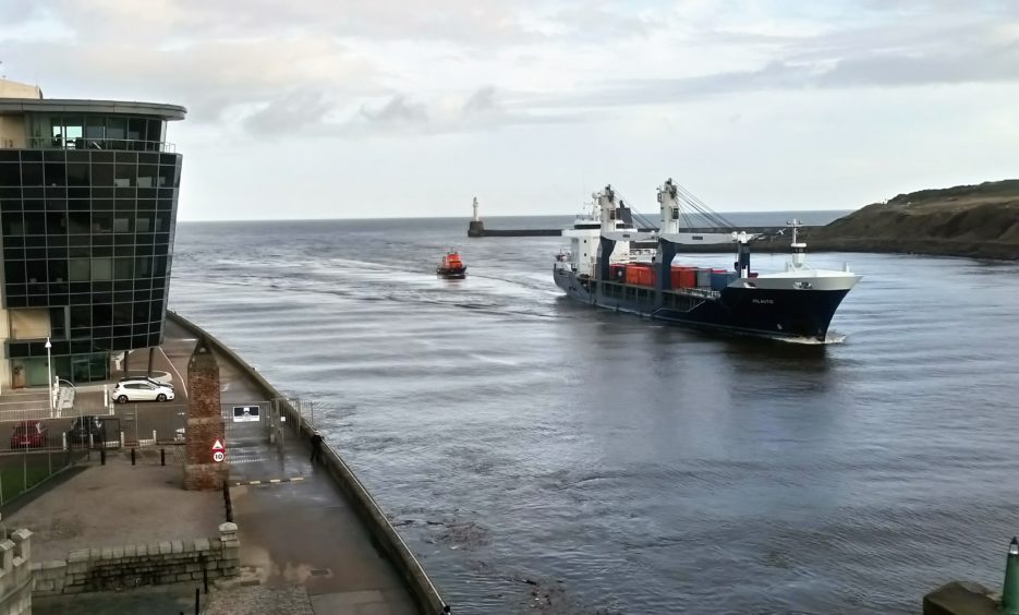 MV Atlantic, with RNLI casualty care crew on board attending injured harbour pilot Ewan Rattray, being escorted to her berth by Aberdeen Lifeboat in 2018.