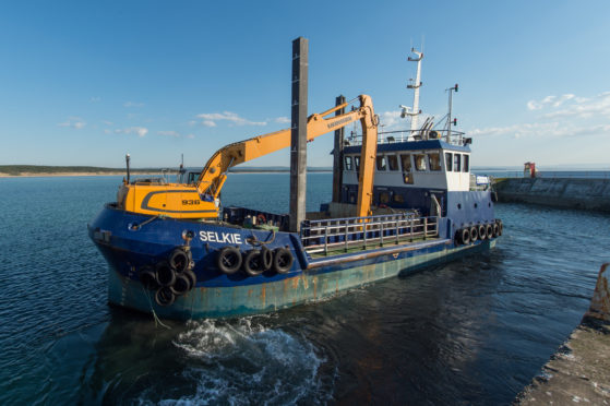 Moray Council's dredger Selkie at Burghead Harbour.