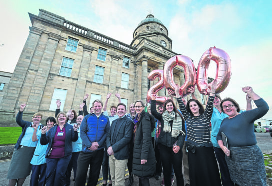 Jamie Hogg, Alasdair Pattison and Liz Tait with hospital staff outside Dr Gray’s to commemorate 200 years since it opened.