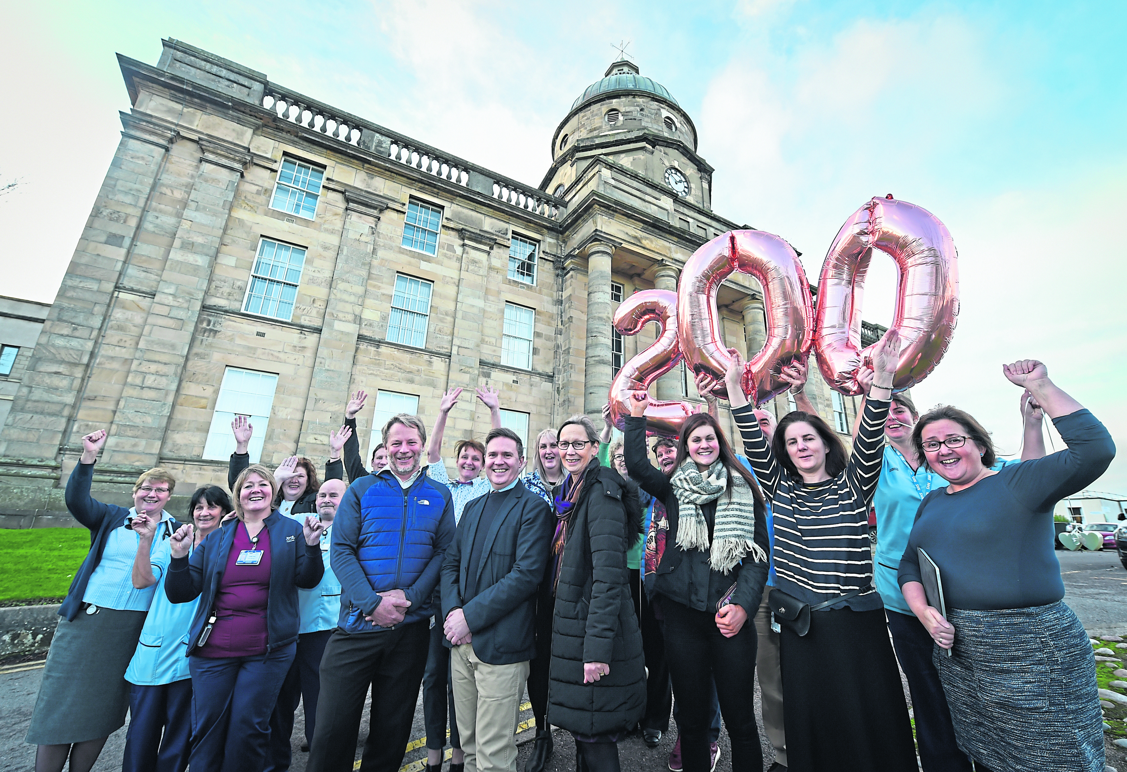Jamie Hogg, Alasdair Pattison and Liz Tait with hospital staff outside Dr Gray’s to commemorate 200 years since it opened.