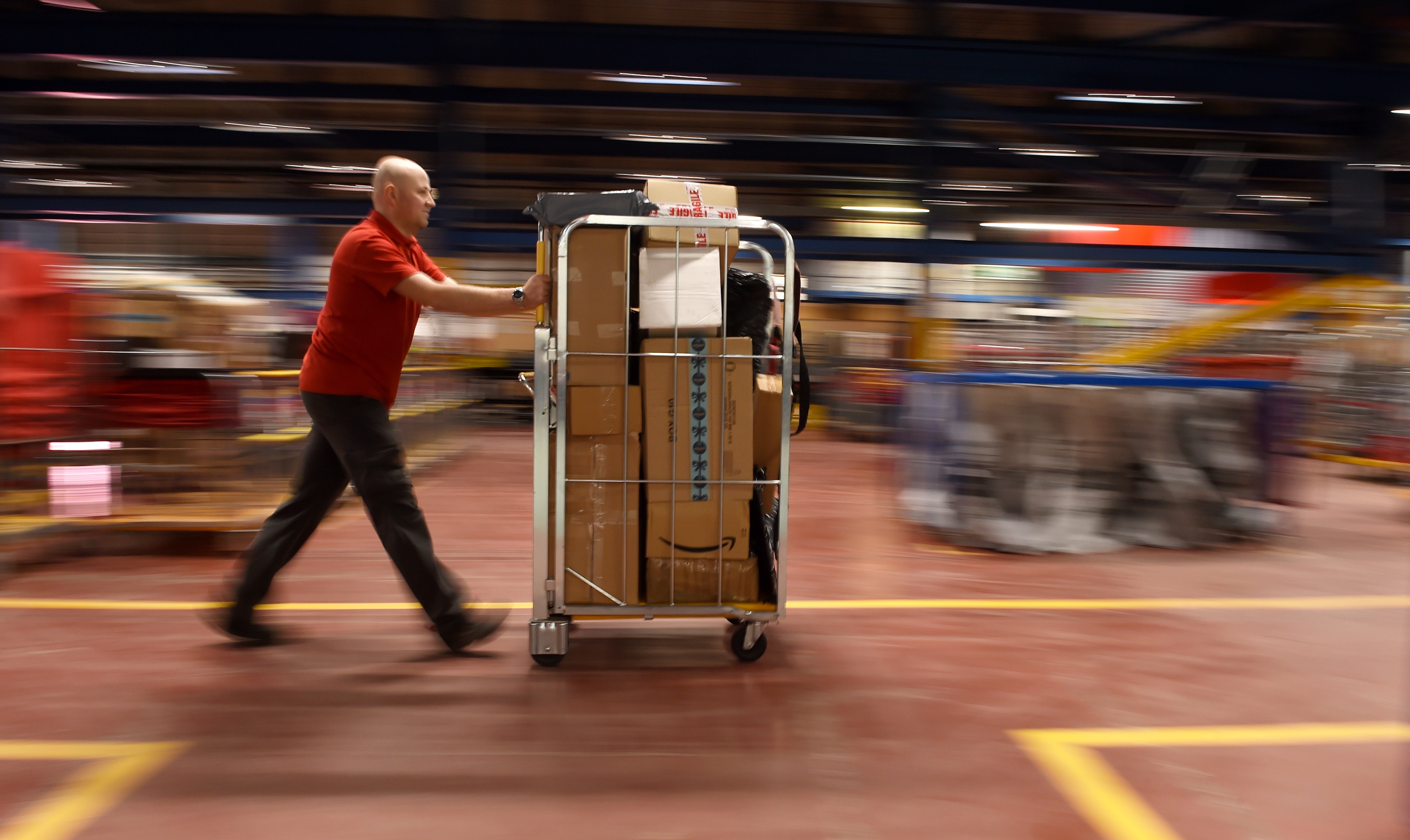 Postal worker Krzysztof Pyrka at work in the busy Inverness Mail Centre. Picture by Sandy McCook