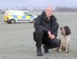 Constable Donald Pearson with his specialist dog, 'Corrie'.