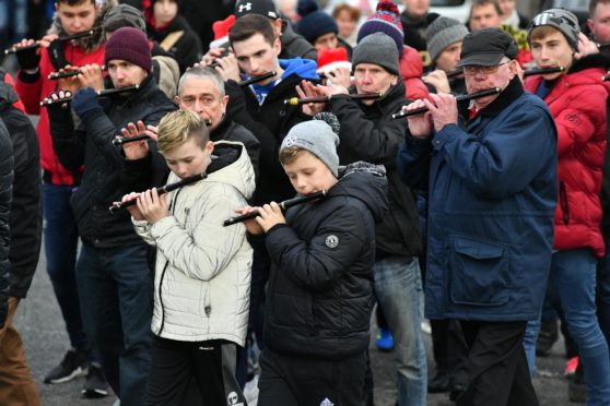 The flute band leads the walk through Cairnbulg.