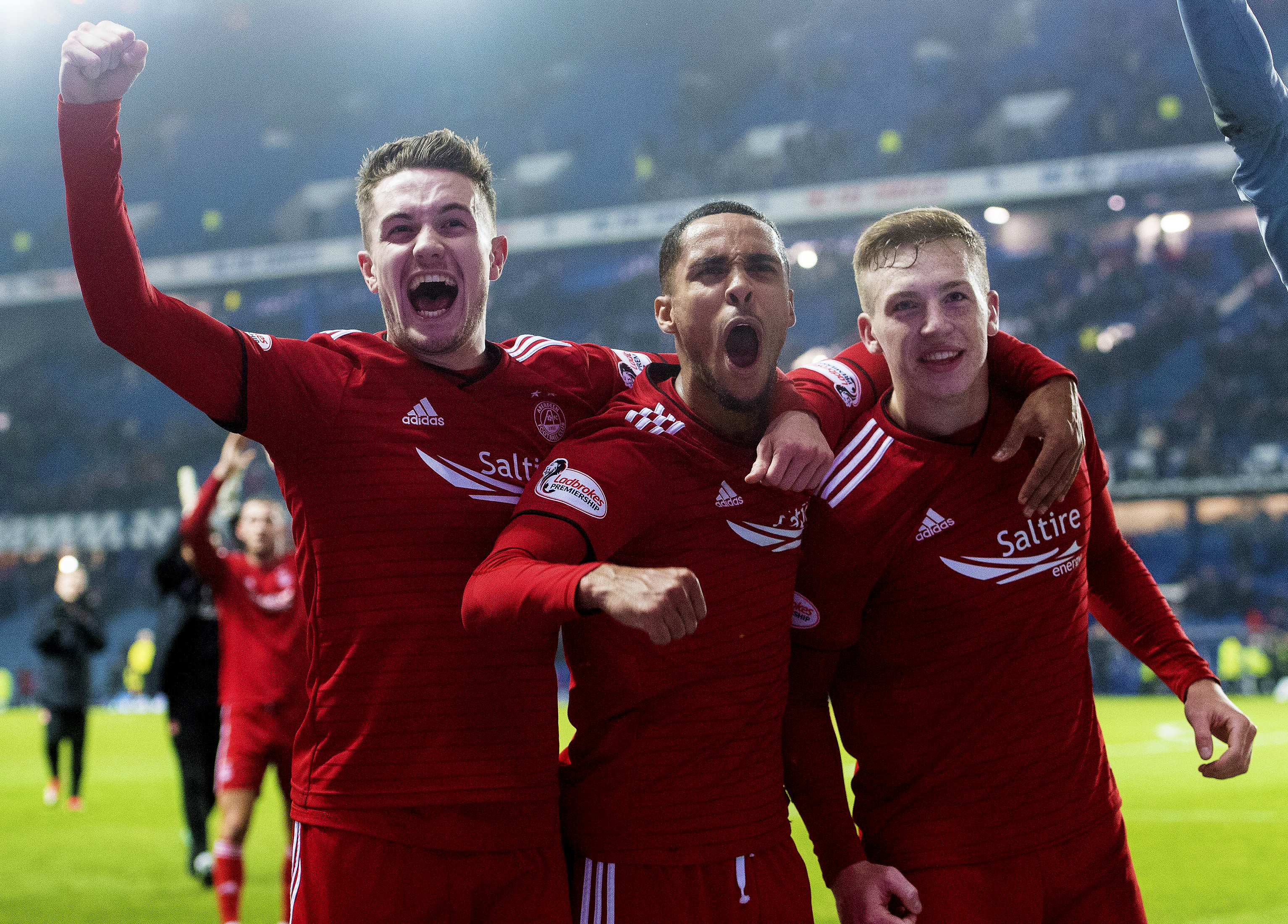 Scott Wright, Max Lowe and Lewis Ferguson celebrate at full-time at Ibrox.