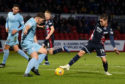 Queen of the South's Callum Semple (L) in action with Ross County's Josh Mullin.