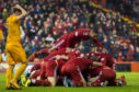 Aberdeen players mob Lewis Ferguson after his late winner.
