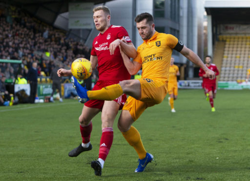 Livingston's Craig Halkett (R) defends from the oncoming Sam Cosgrove