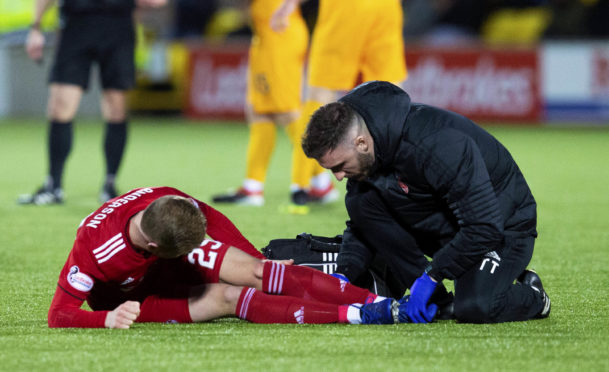 Aberdeen's Bruce Anderson receives treatment from the physio at Livingston.