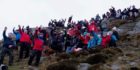 Around 80 people climbed Bennachie in aid of two terminally ill people.
