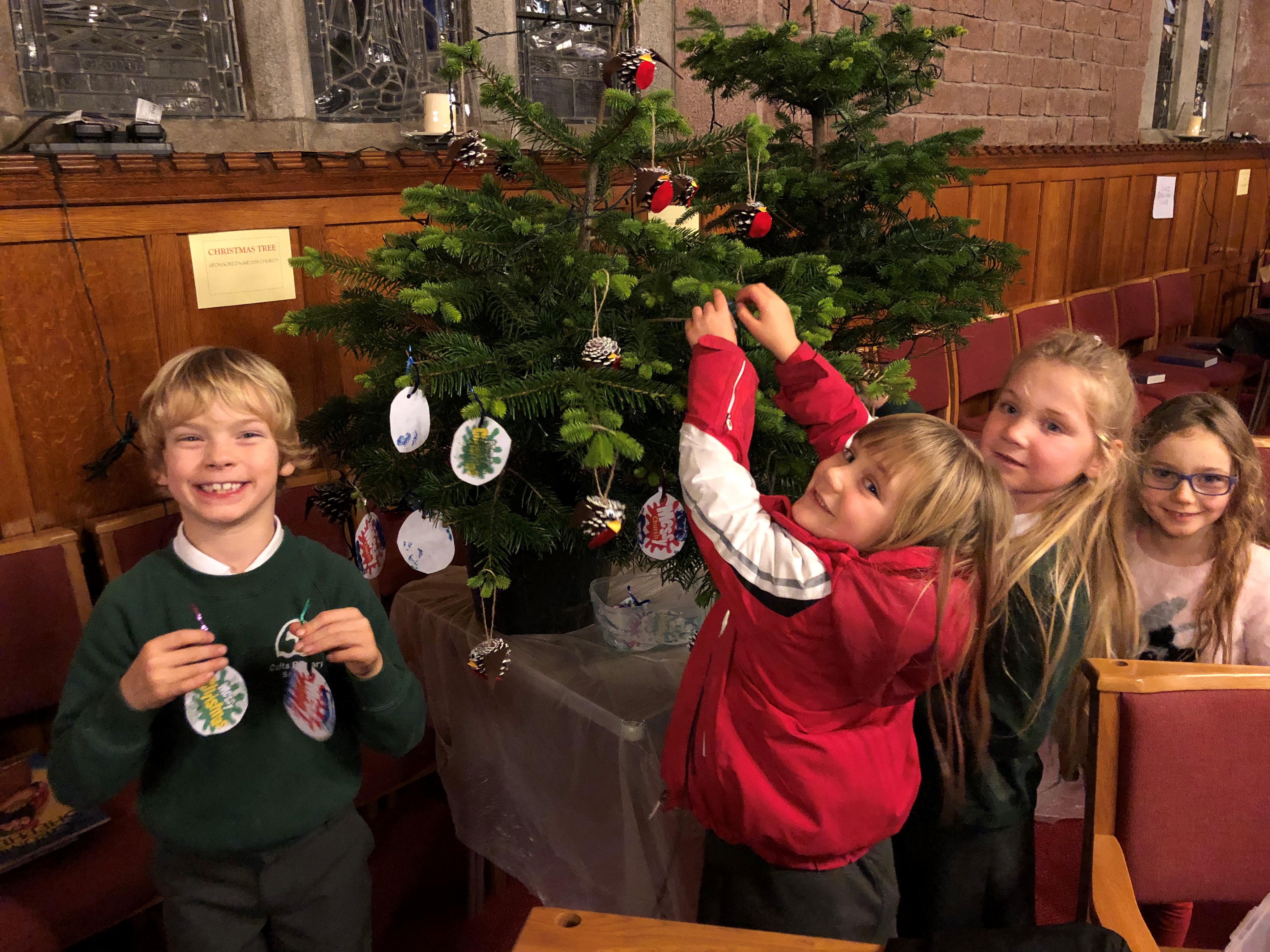 Children from Messy Church decorating their tree