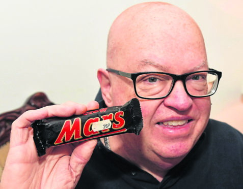 Peterhead man Willie Knight with his 'vintage' mars bar which attracted over 1200 hits when he listed it for sale.