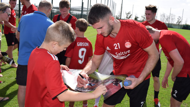 Dominic Ball signs autographs for fans at yesterday's open training session. Picture: AFC Media.