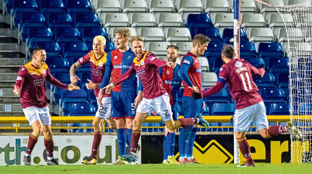 Queen of the South's Scott Mercer celebrates his equaliser.