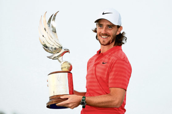 Tommy Fleetwood celebrates with the Abu Dhabi HSBC Golf Championship trophy