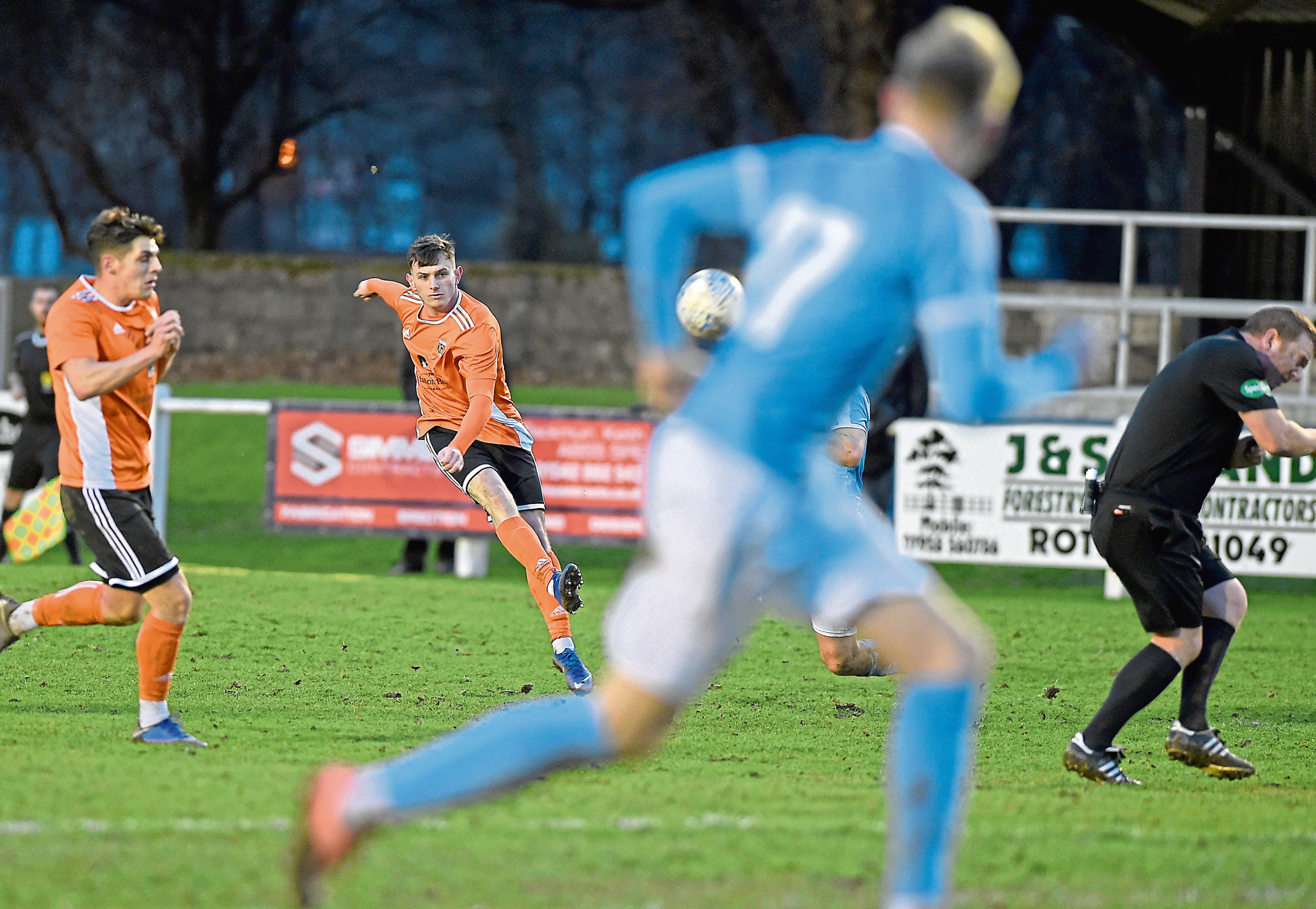 Referee Alan Proctor ducks as Alisdair Sutherland of Rothes scores his teams opening goal from well outside the box.