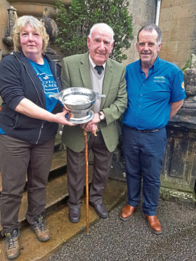 NFU Scotland Argyll and the Islands Stalwart Award winner Sandy McKirdy (Centre) receiving the award from John Dickson and Sybil MacPherson