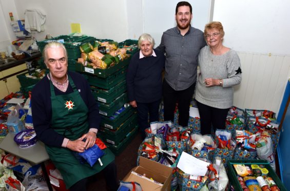 Angus Hay, Mary Kitchen, pastor Rob McArthur and Wendy Boothroyd show off the food donations.