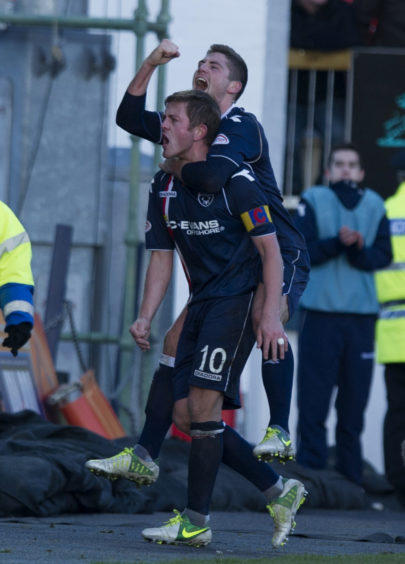 Ross County captain Richard Brittain celebrates his part in his side's third goal with team-mate Iain Vigurs (top).