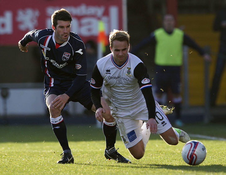 ICT's Andrew Shinnie loses his footing under pressure from Rocco Quinn (left)